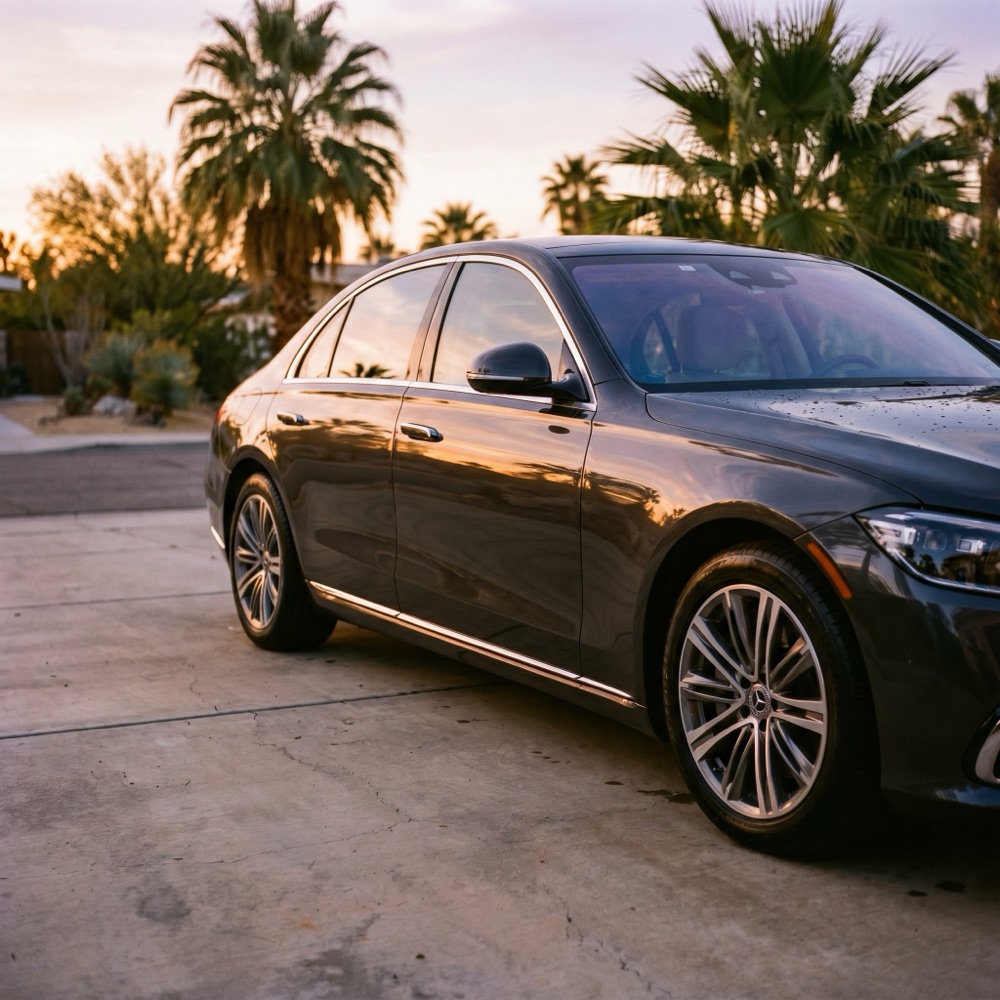 A freshly detailed car gleaming with deep gloss at golden hour